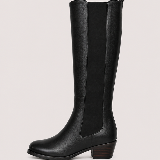 flat lay of a leather boot with an elastic strip down the side on a white background 