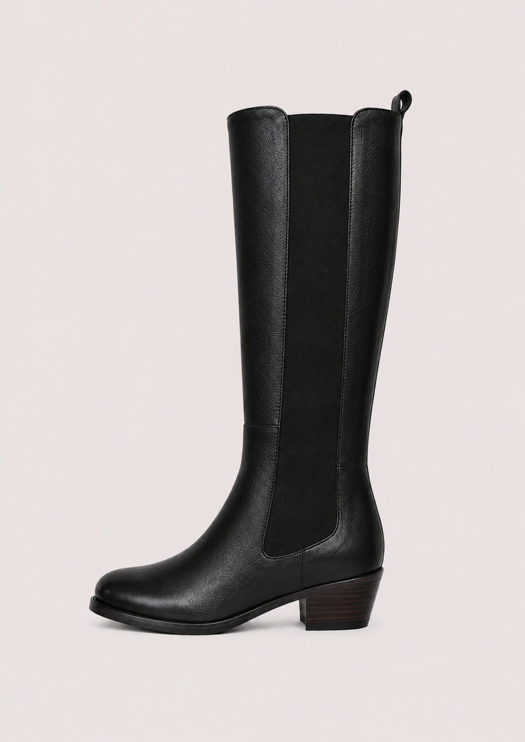 flat lay of a leather boot with an elastic strip down the side on a white background 