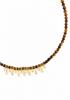 A beaded necklace featuring round brown and golden-brown tiger's eye beads with a fringe of gold-toned settings holding clear teardrop gemstones, shown against a plain white background.