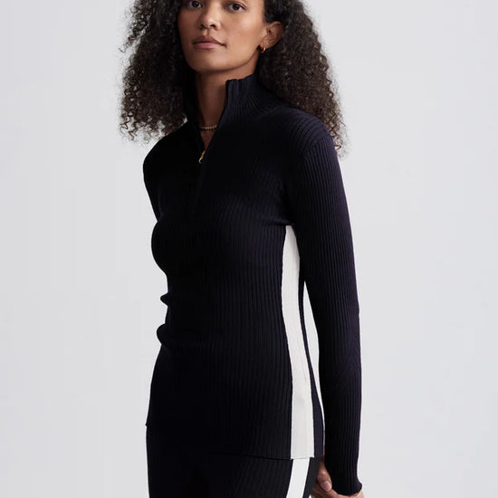 black ribbed jumper with zipped neck and white panel on side 