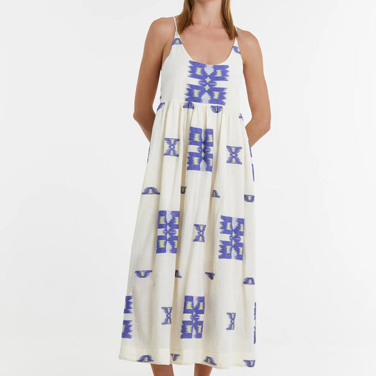 Ecru midi dress with empire line and spaghetti straps that cross at the back with blue and lime abstract woven design throughout