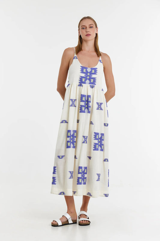 Ecru midi dress with empire line and spaghetti straps that cross at the back with blue and lime abstract woven design throughout