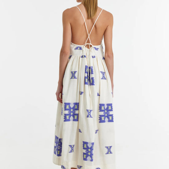 Ecru midi dress with empire line and spaghetti straps that cross at the back with blue and lime abstract woven design throughout