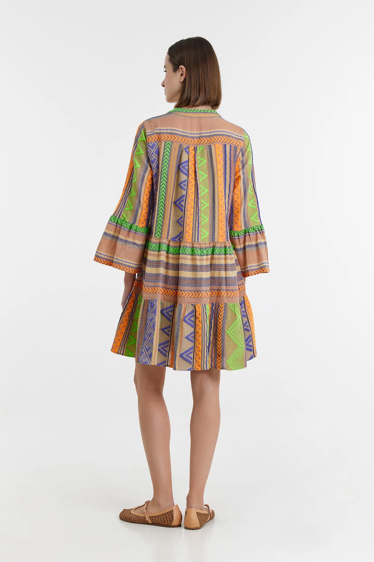 Biege notch neck beach dress with long fluted sleeves and tiered skirt with neon green orange and purple embroidery