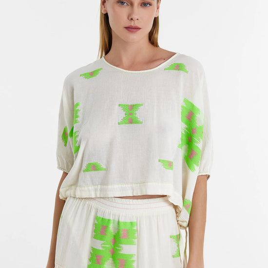 Short top with grown on short sleeves with elasticated cuffs and drawstring waist with cornflower pink and green woven abstract bold shapes throughout boxy fit