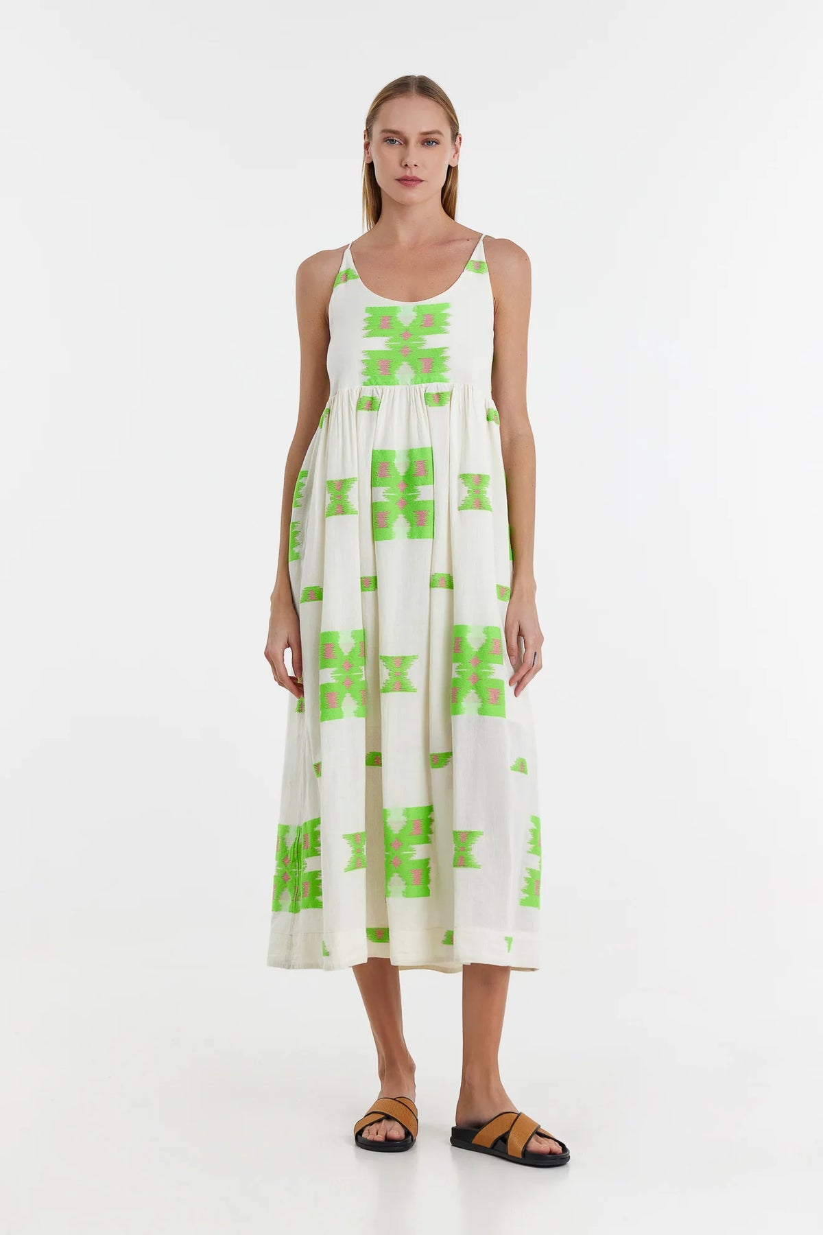 Ecru midi dress with empire line and spaghetti straps that cross at the back with green and pink abstract woven design throughout