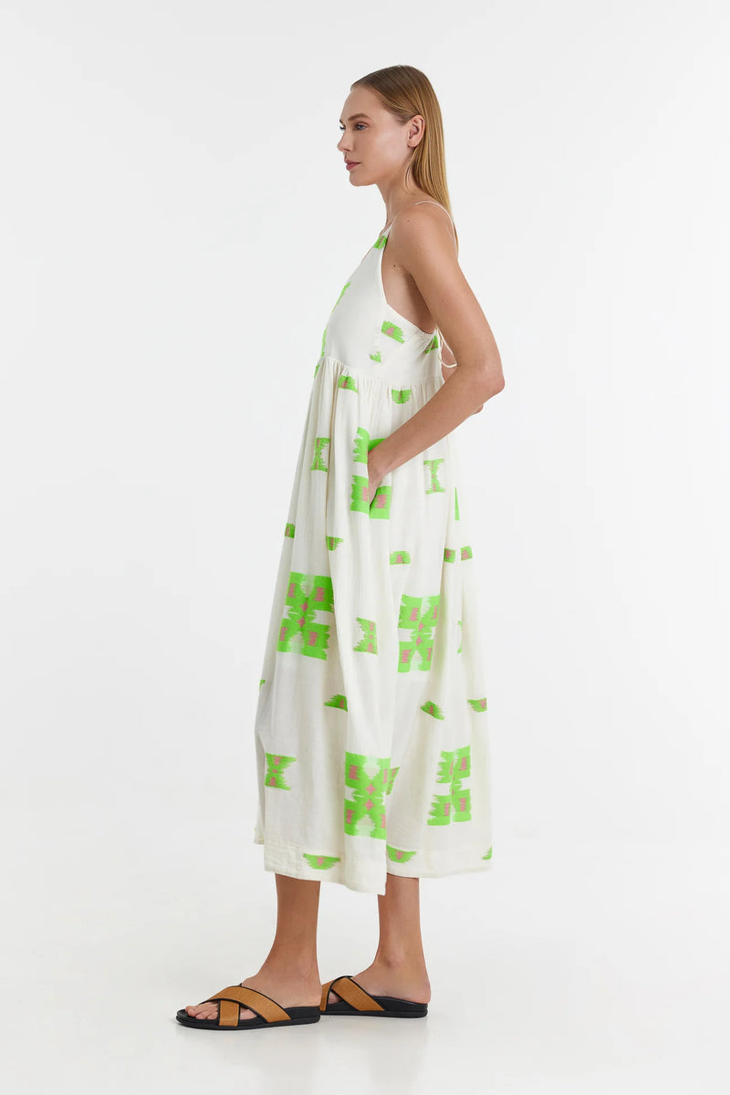 Ecru midi dress with empire line and spaghetti straps that cross at the back with green and pink abstract woven design throughout