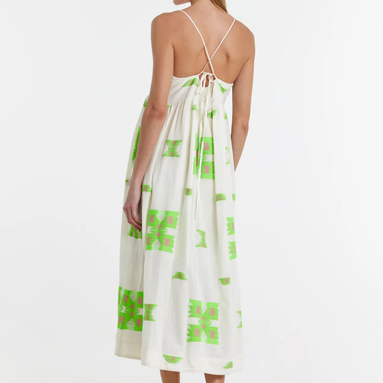 Ecru midi dress with empire line and spaghetti straps that cross at the back with green and pink abstract woven design throughout