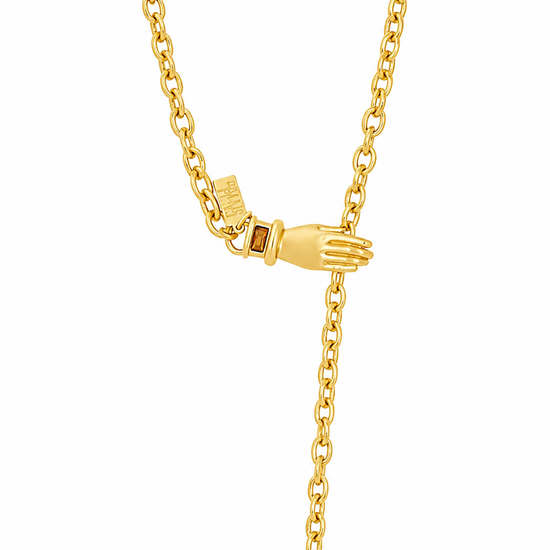 A gold chain necklace with a small hand-shaped charm and an adjustable drop tail, displayed on a clean white background.