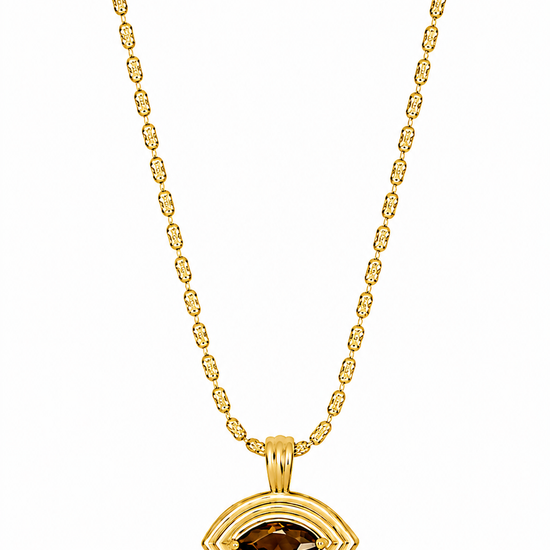 flat lay of a gold necklace with an evil eye pendant with a brown tigers eye stone on the pendant 