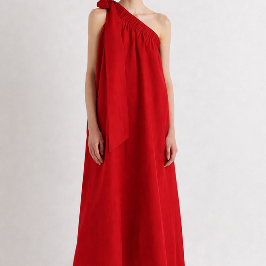 Woman wearing a red one-shoulder dress on a white background