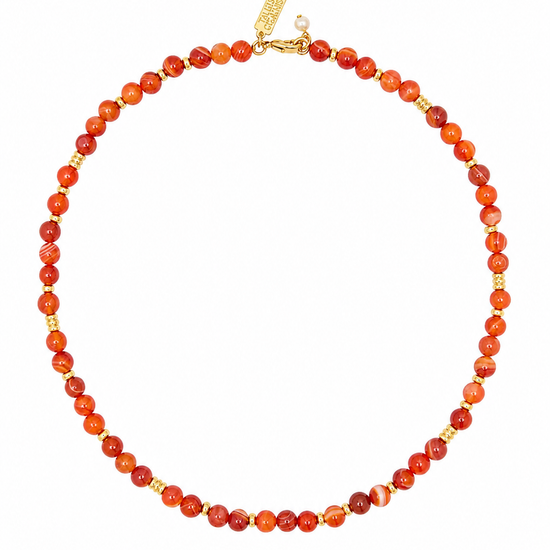 A beaded necklace made of round orange-red marbled beads with small gold spacer beads and a gold clasp, shown on a plain white background.