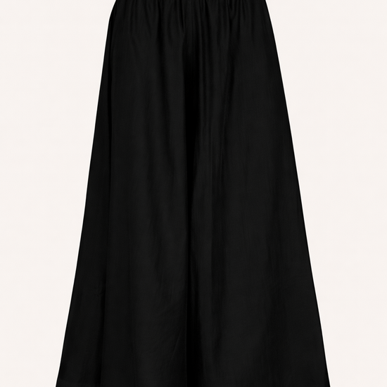 Black wide leg trousers on a light beige background