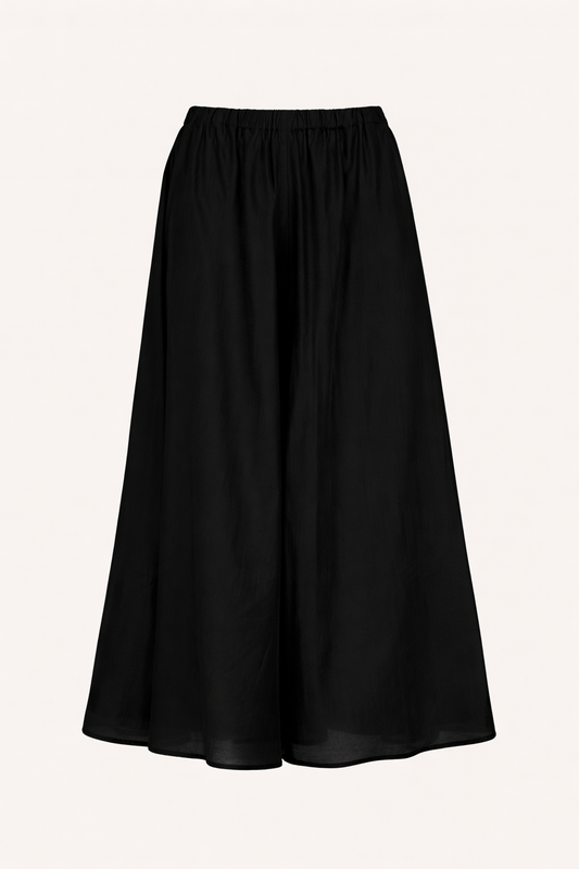 Black wide leg trousers on a light beige background