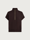 Black short-sleeve top with a gold zipper on a light gray background