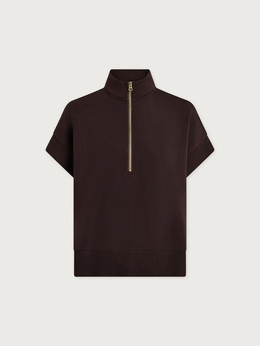 Black short-sleeve top with a gold zipper on a light gray background