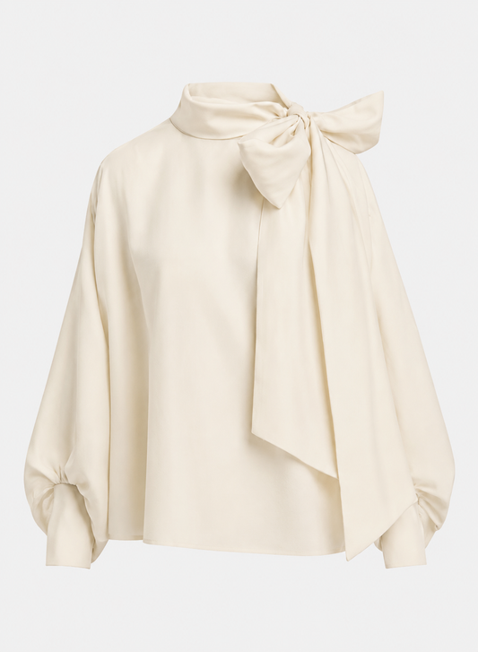 An off-white satin blouse with a high neck, large bow at the collar, and balloon sleeves, shown on a light gray background.