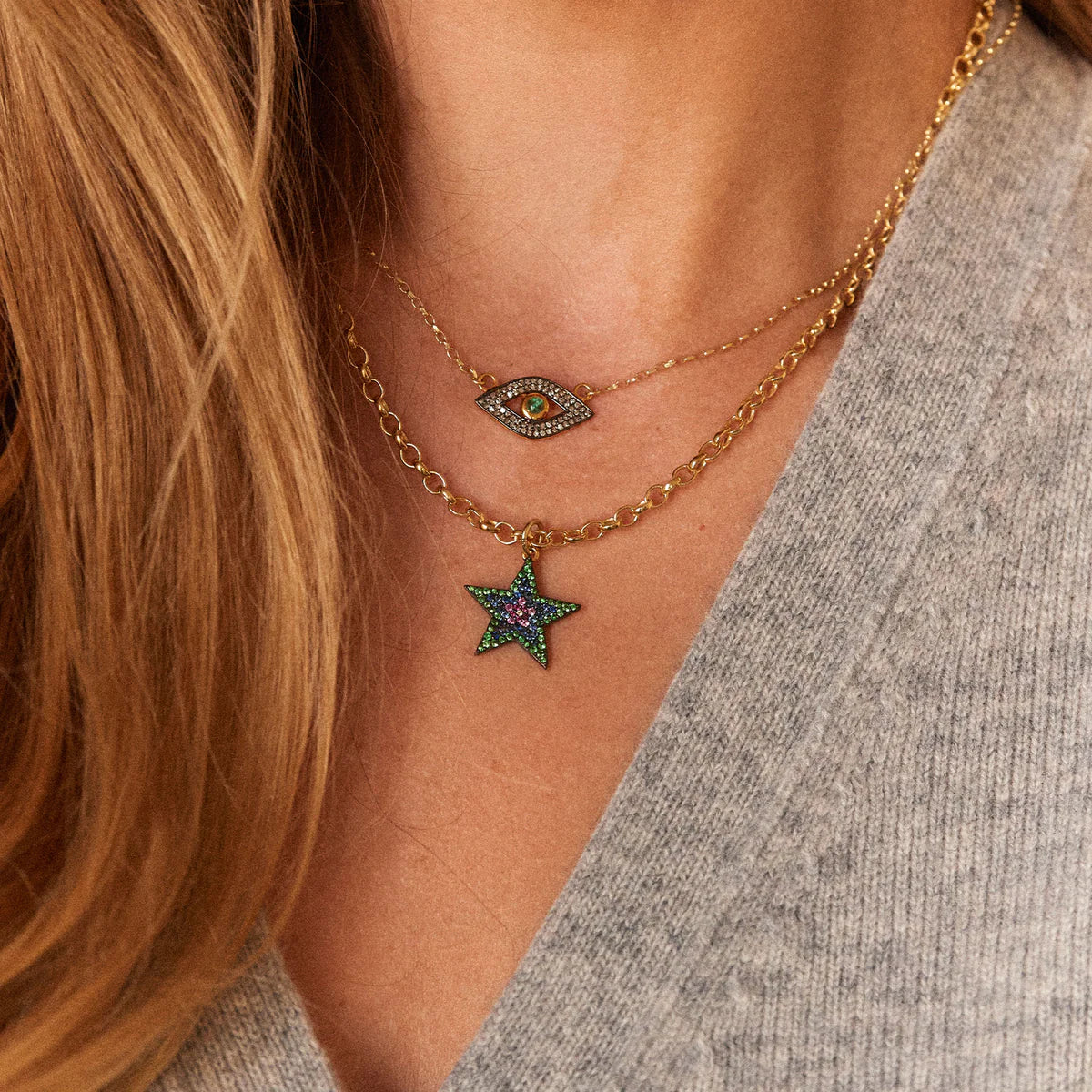 Gold chain necklace with star pendant featuring pave blue and pink sapphires and Tsavorite diamonds