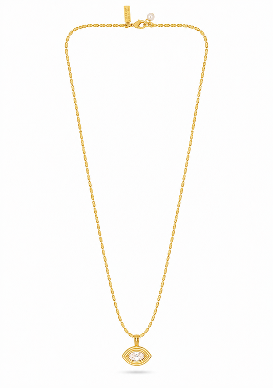 A gold chain necklace with a small oval pendant featuring a clear central stone, displayed against a plain white background.