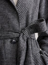 black houndstooth coat with tie belt close up