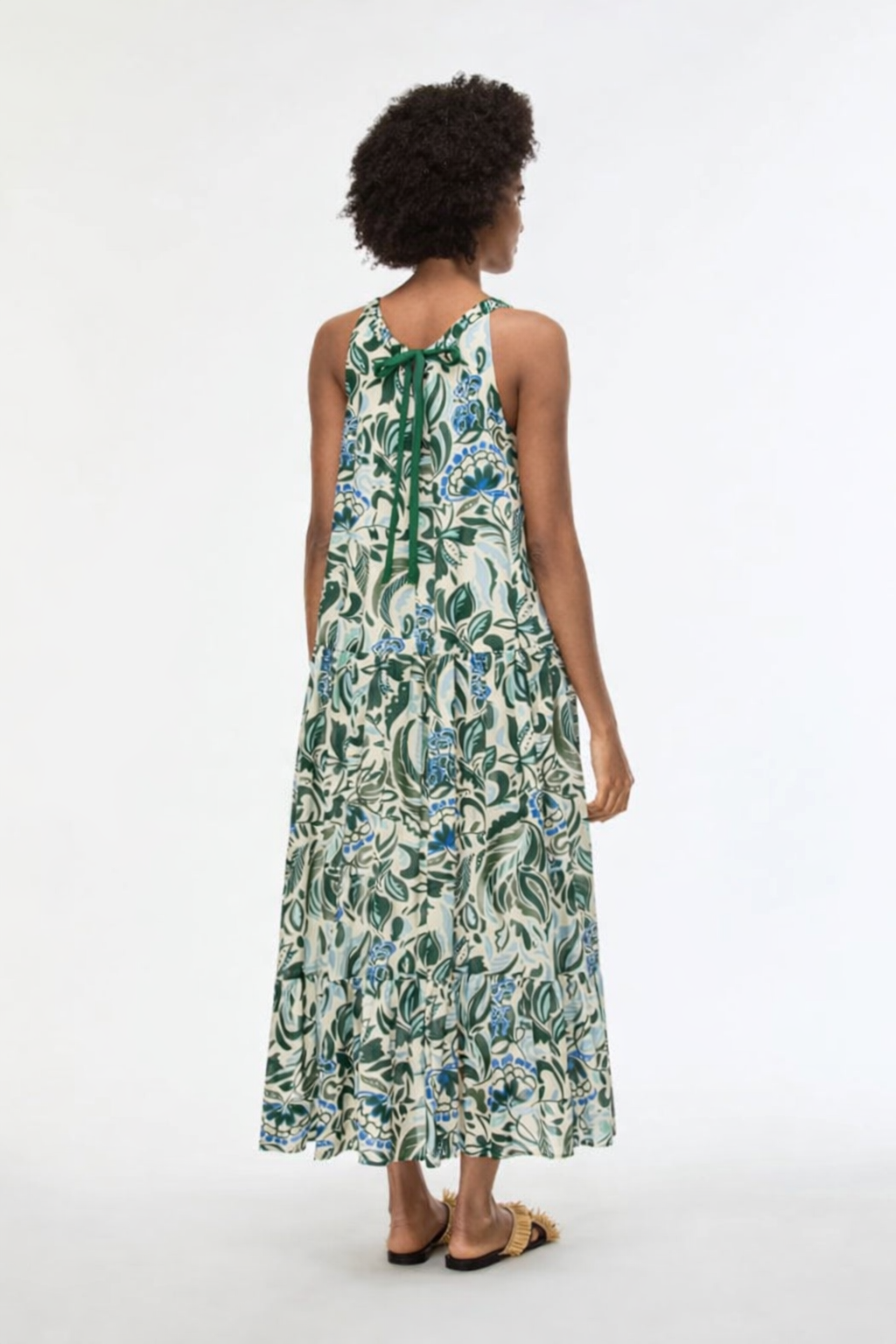 woman from the back wearing floral green dress 