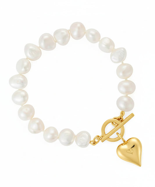 Pearl bracelet with a gold clasp and heart charm on a white background