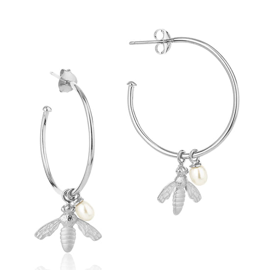 Large silver hoop earrings with flying bee pendants and a rice pearl drop with butterfly earring fastenings