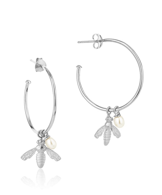 Large silver hoop earrings with flying bee pendants and a rice pearl drop with butterfly earring fastenings