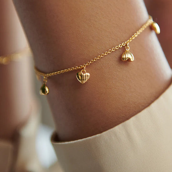 gold chain bracelet with gold heart charms and a lobster clasp from rachel jackson model shot