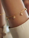 gold chain bracelet with gold heart charms and a lobster clasp from rachel jackson model shot