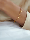 gold chain bracelet with gold heart charms and a lobster clasp from rachel jackson model shot