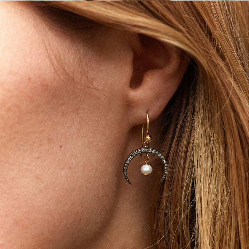 Earrings with hook fastening with oxidised horn shape with tiny pearl suspended from the centre