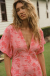 pink floral v neck dress with a line skirt close up