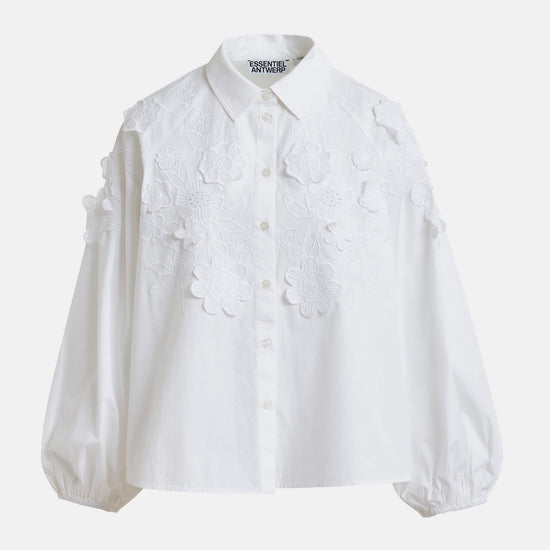 White blouse with floral applique details by Essentiel Antwerp on a white background
