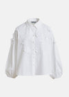 White blouse with floral applique details by Essentiel Antwerp on a white background
