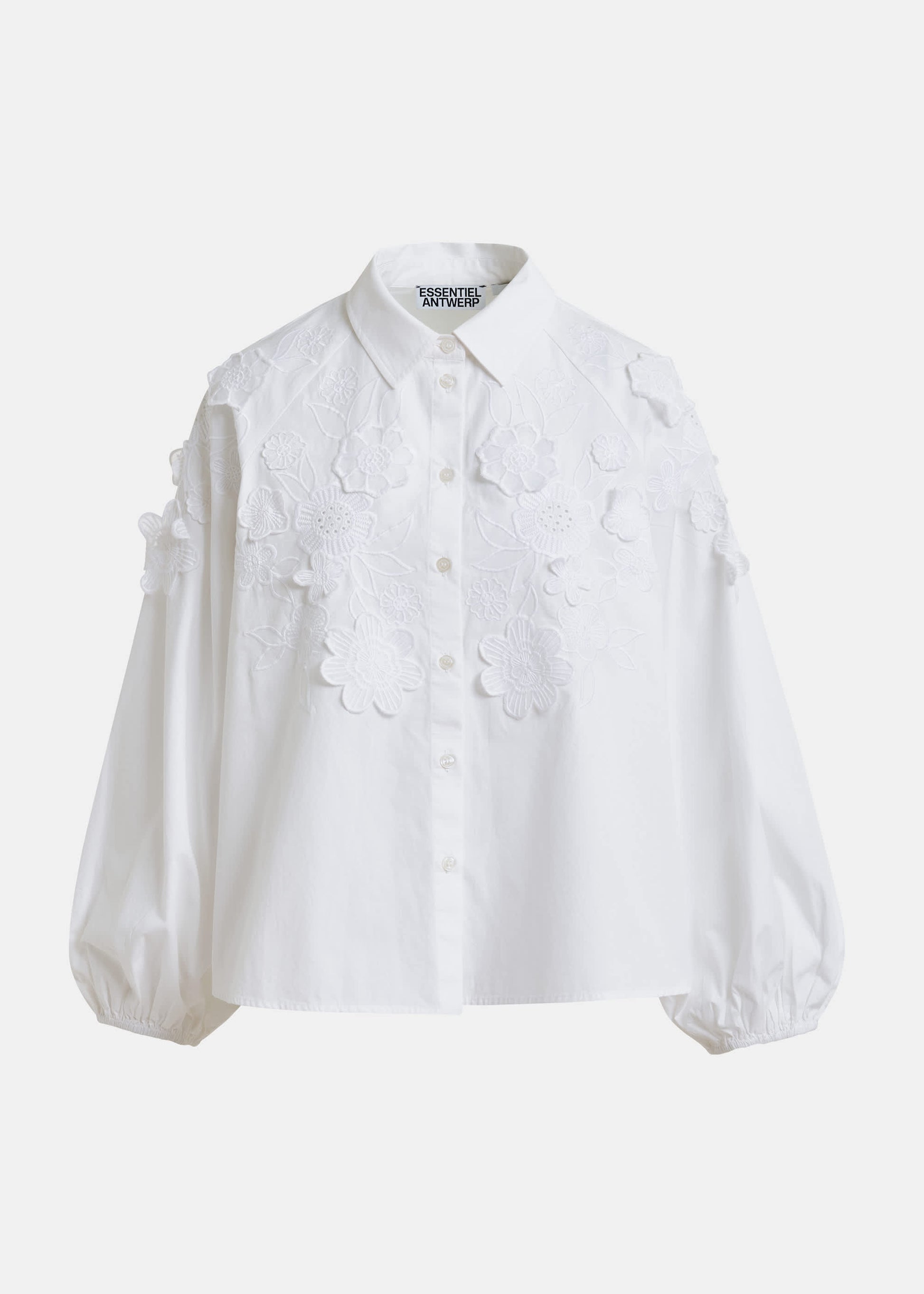 White blouse with floral applique details by Essentiel Antwerp on a white background