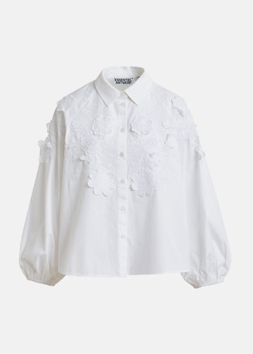 White blouse with floral applique details by Essentiel Antwerp on a white background