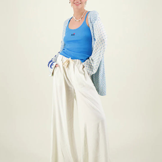 Cream linen wide leg trousers with elasticated waistband and drawstring waist with inseam side pockets