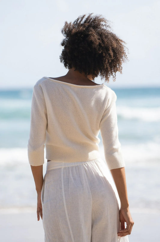 V neck rolled hem cardigan in ivory with three quarter length sleeves and shell buttons