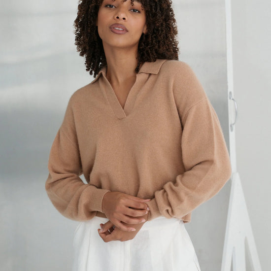 Woman wearing a camel sweater and white pants against a neutral background from Lilly Pilly