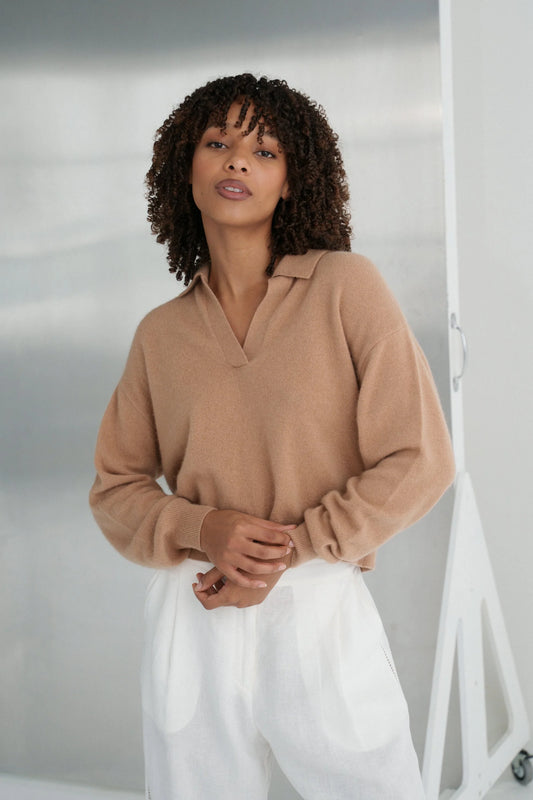Woman wearing a camel sweater and white pants against a neutral background from Lilly Pilly
