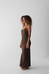 Woman wearing brown cami and skirt set side view