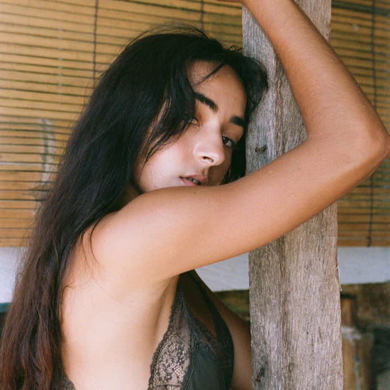 khaki silk mid length slip dress with spaghetti straps and lace detailing close up