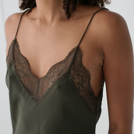 khaki silk mid length slip dress with spaghetti straps and lace detailing close up