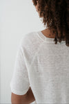Person wearing a light gray sweater against a white background