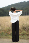 Over size white linen shirt with 3/4 length sleeves rear view