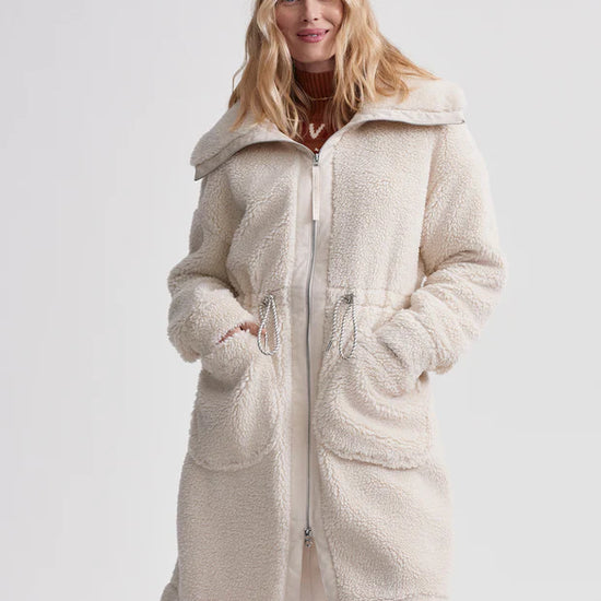 cream sherpa coat with high neck, 2 large patch pockets and drawstring waist