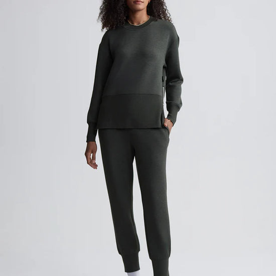 dark green sweater with round neck and zip detail model shot