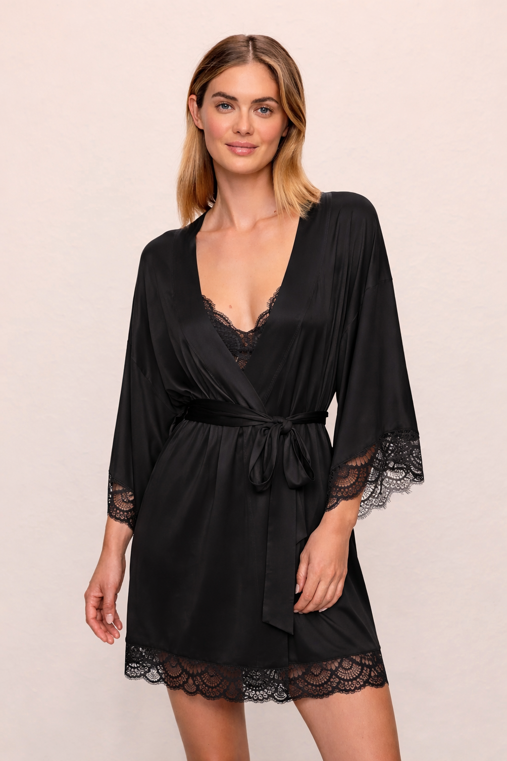 model wearing black robe on plain background 