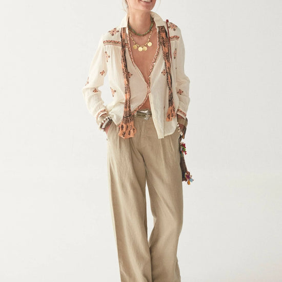 Light khaki wide leg linen trousers with pleated front zip fly and button fastening